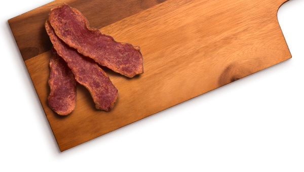 bacon slices on wood cutting board